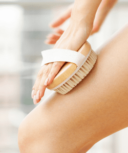 Natural bristle dry brush with an easy-to-grip handle, perfect for exfoliation and promoting lymphatic drainage.