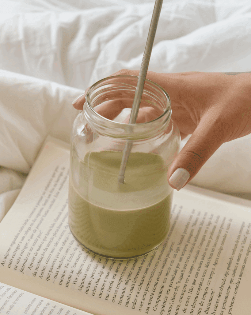 Matcha wellness drink resting on a book as part of a mindful ritual turned habit