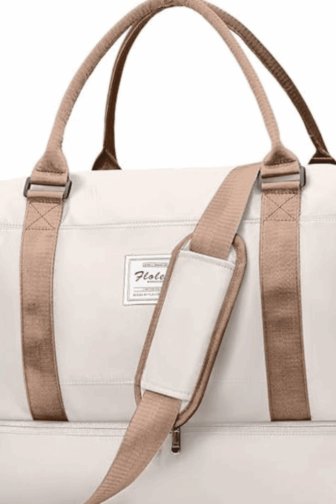 Neutral weekender tote with trolley sleeve styled for minimalist travel, perfect for packing airport outfit and bag essentials.