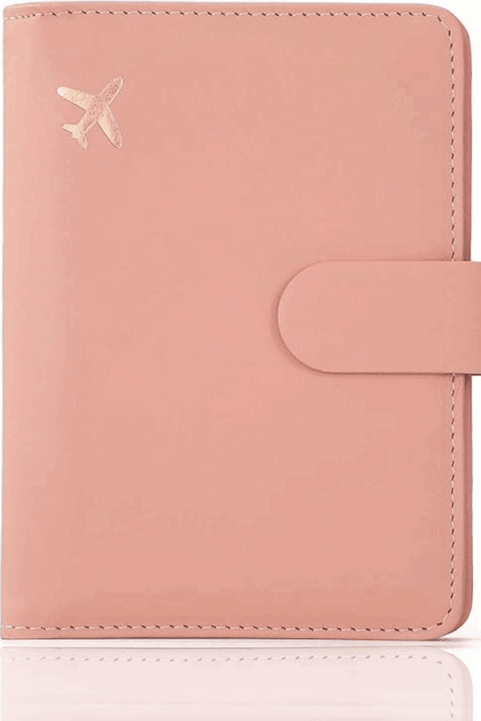 Blush-toned travel wallet with passport and boarding pass partially visible, a stylish way to organize travel documents.