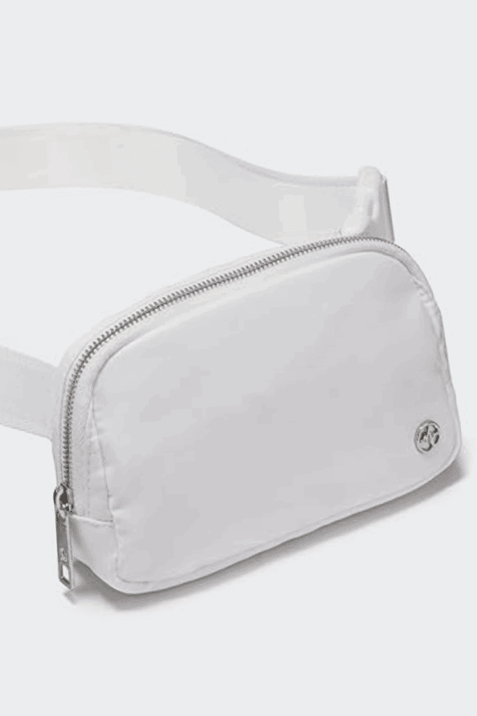 White belt bag worn crossbody over a neutral outfit – affordable fashion waist pack inspired by the Lululemon Everywhere Bag.