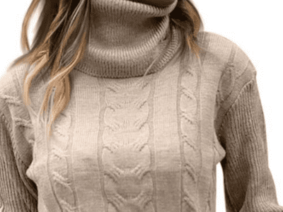 A close up of a women's body wearing a cream chunky turtleneck.
